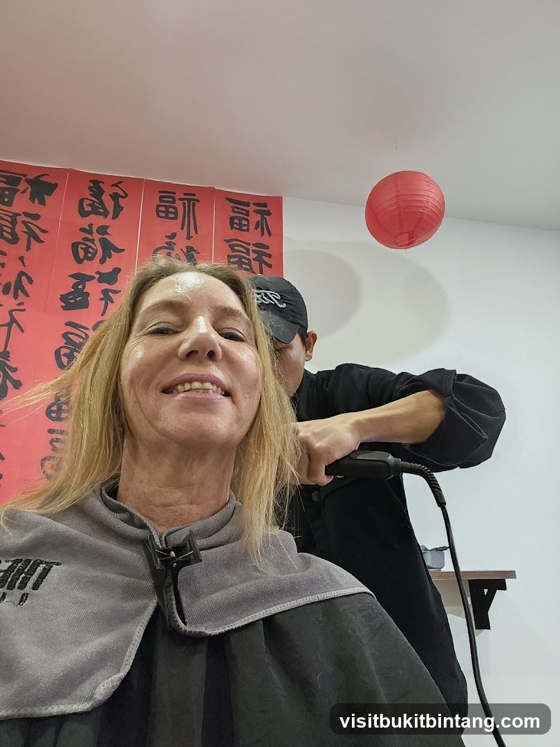 Hairdresser straightening client's hair