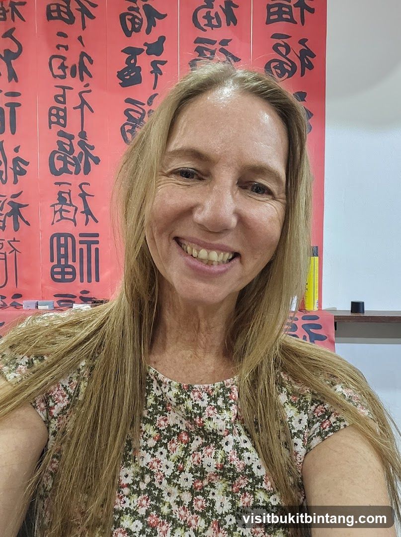 Woman in front of calligraphy