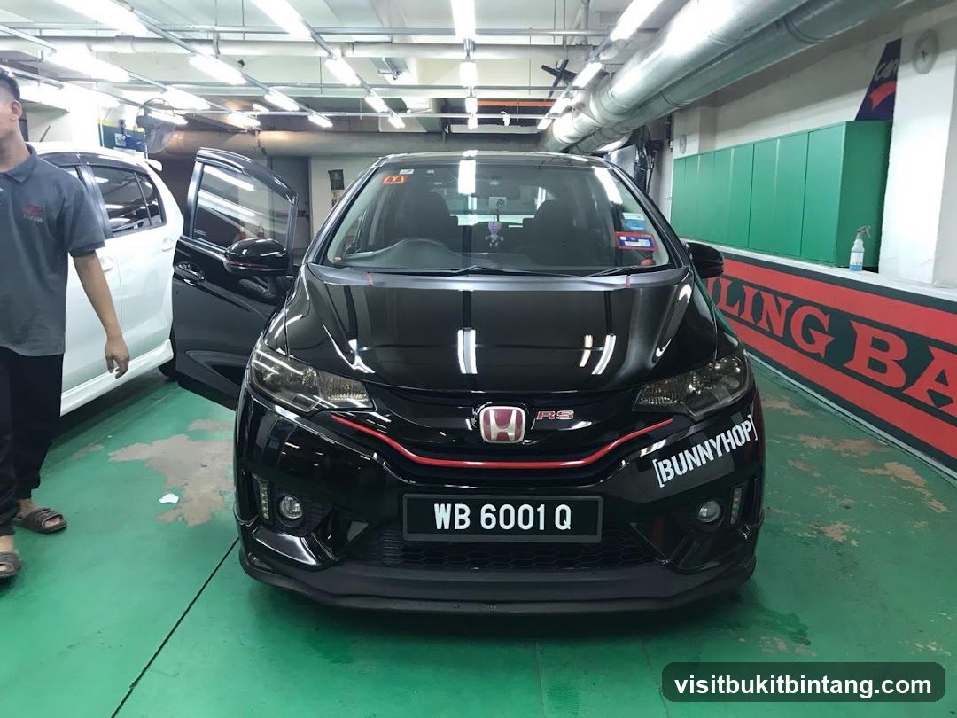 Black Honda Jazz with Custom Sticker