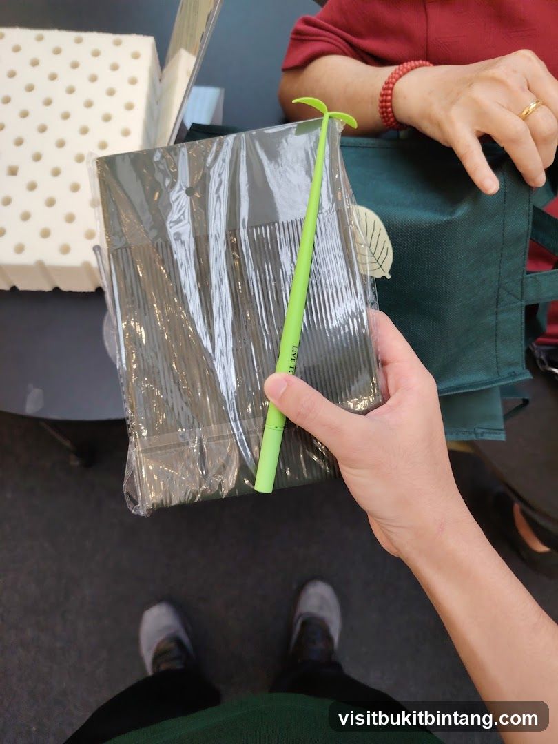 Person holding a pen and a packaged item
