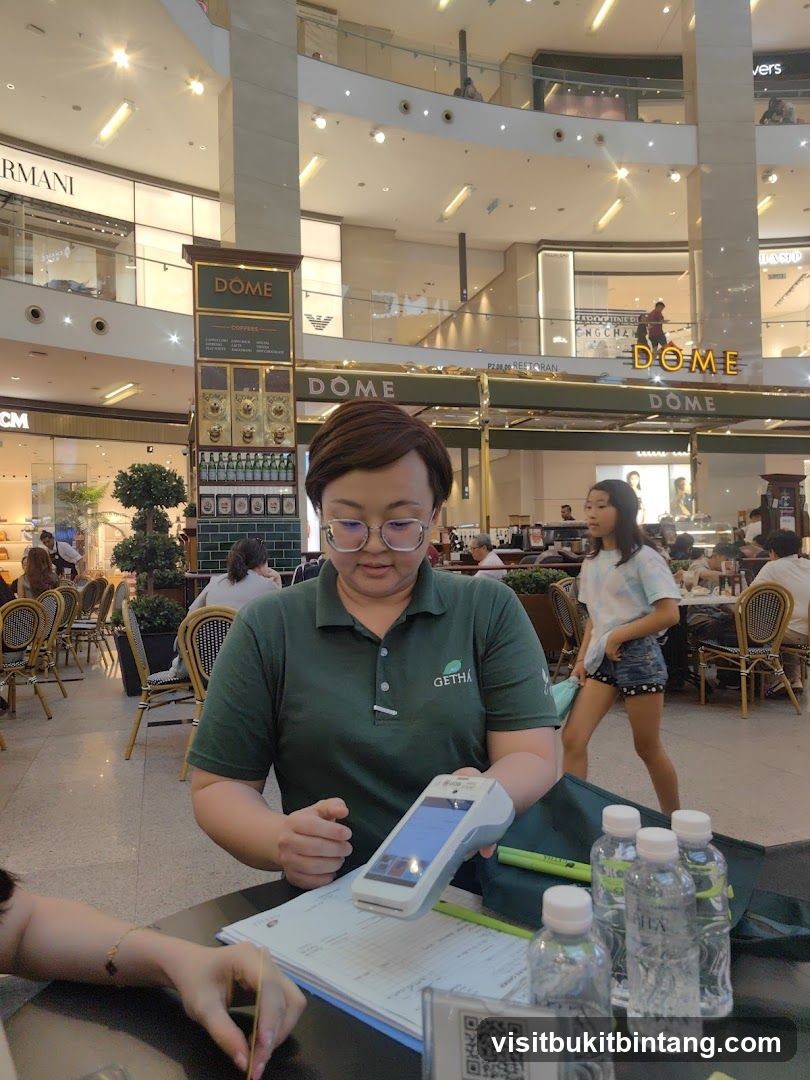 Cafe Interior with Staff Processing Payment
