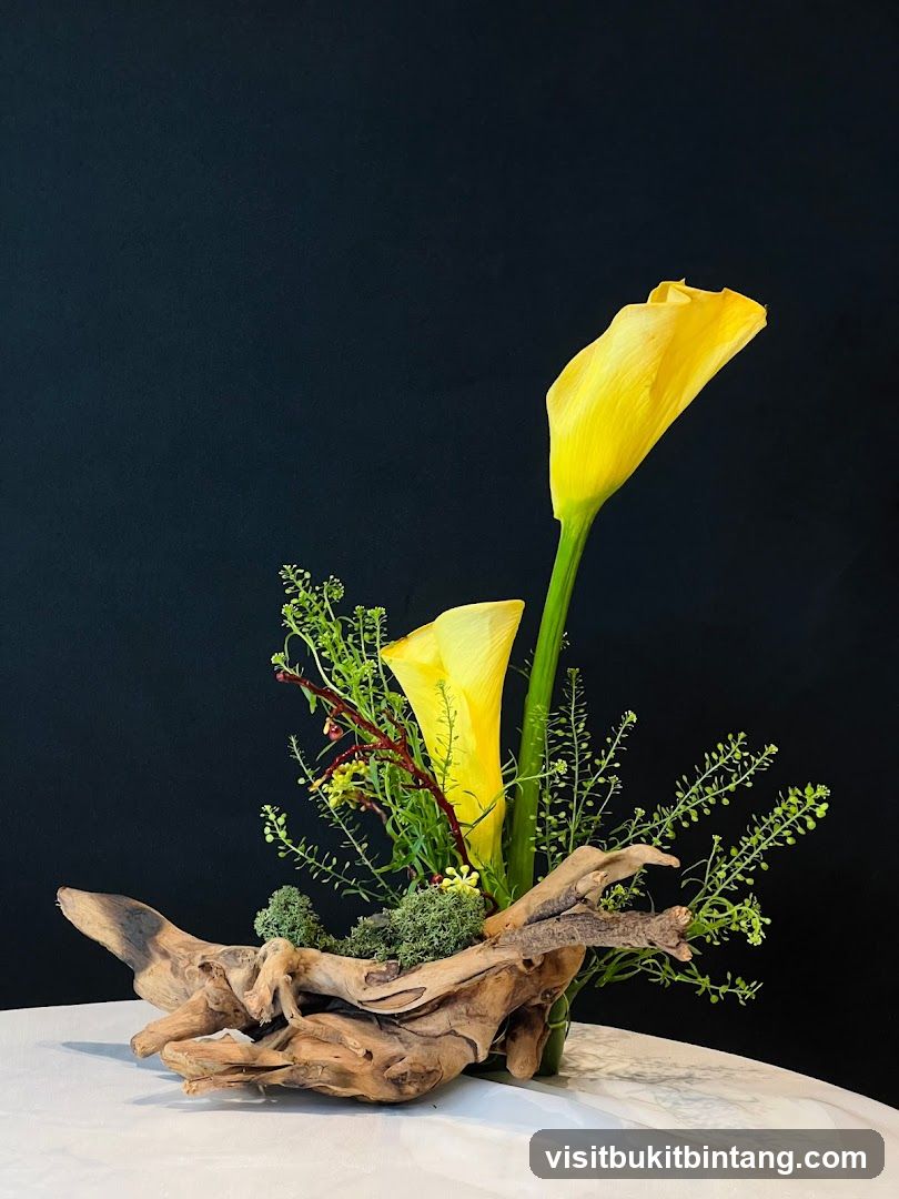 Floral Arrangement with Yellow Calla Lilies and Driftwood