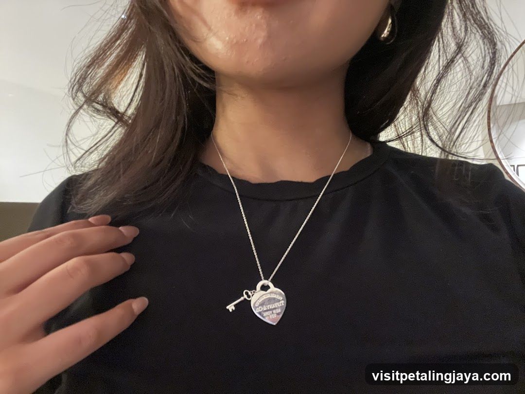 Heart-shaped pendant necklace on black shirt
