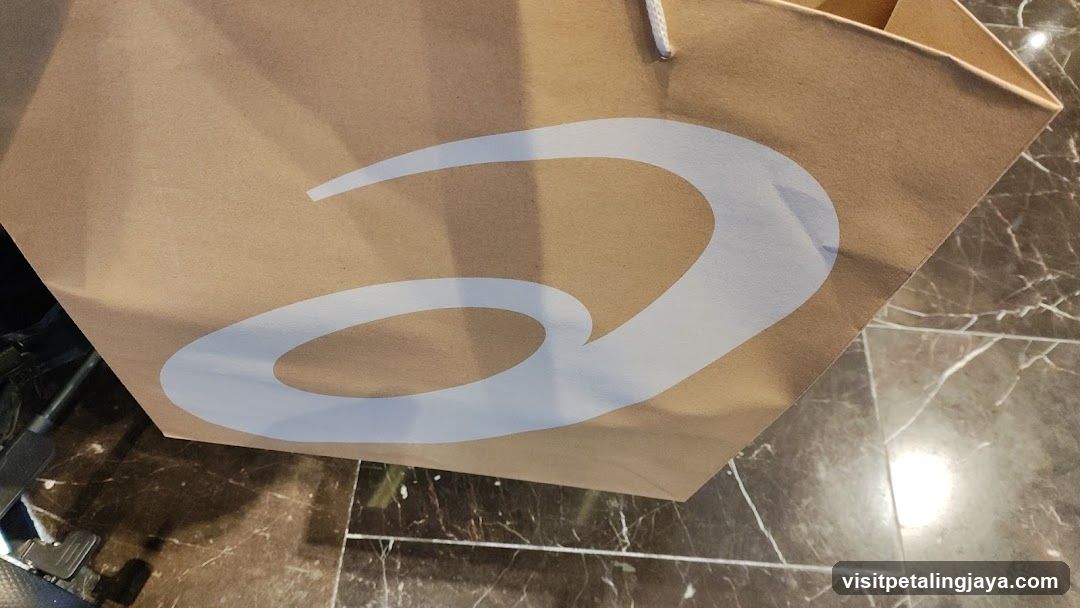Brown paper shopping bag with white logo