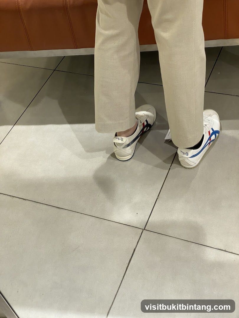 Person wearing white sneakers
