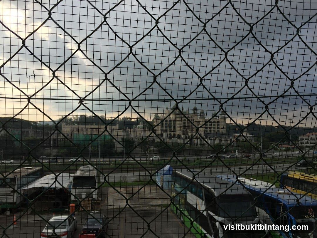 Buses parked near a large building