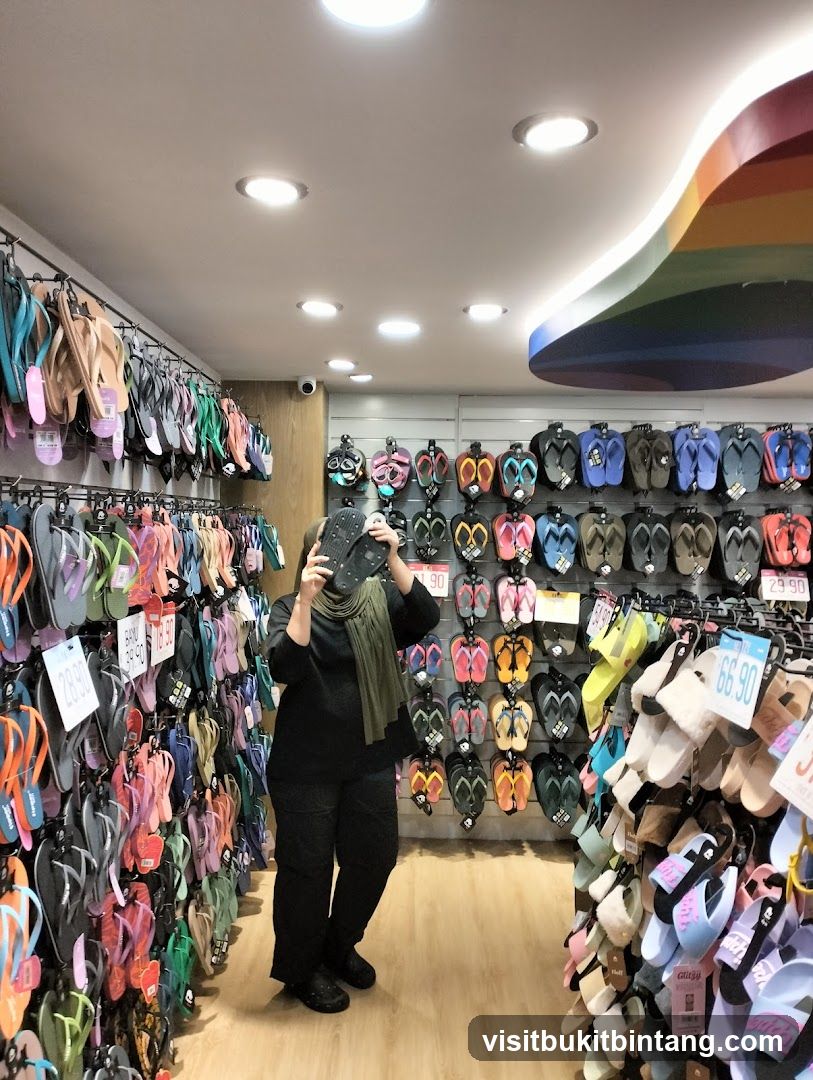 A person holding a phone in a flip-flop store