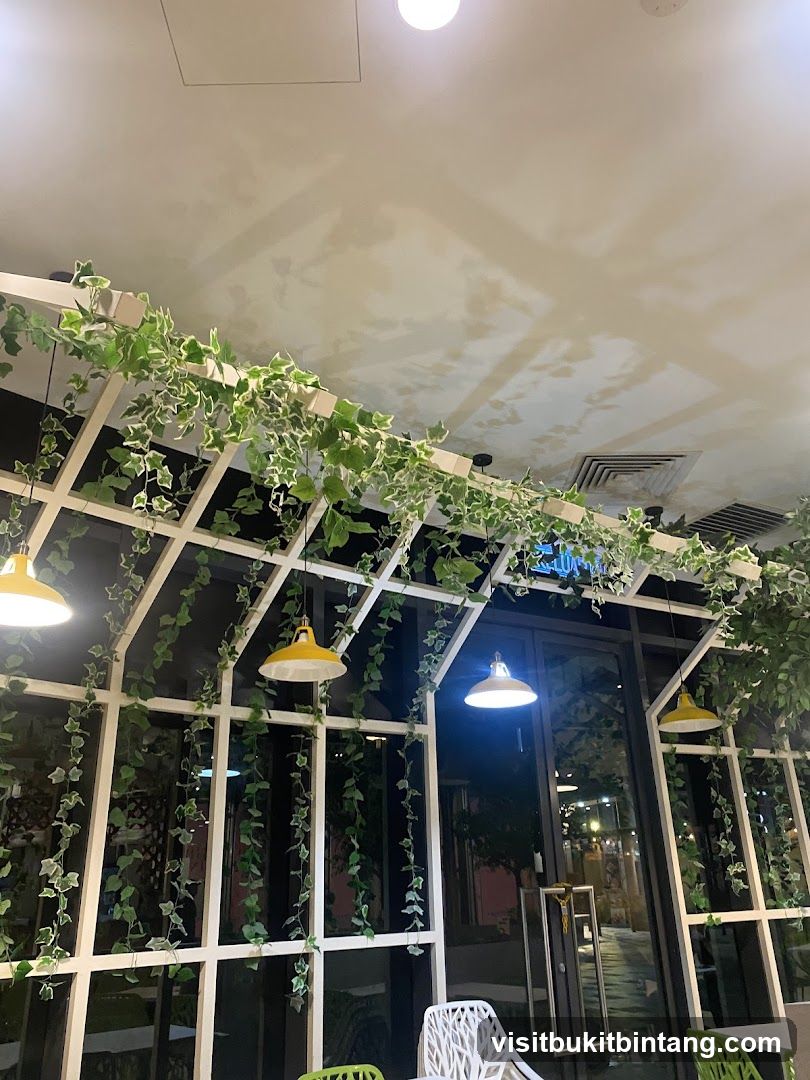 Cafe Interior with Greenery and Yellow Lamps