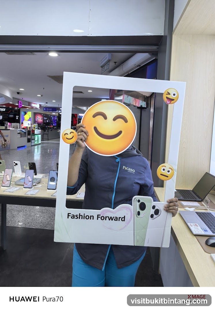 Person holding a photo frame with emojis and phones