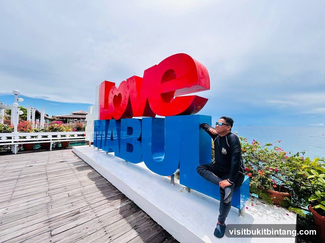 Man posing by large "Love MABUL" sign