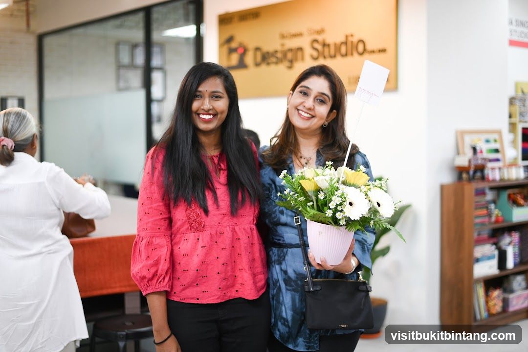 Two women with a flower arrangement