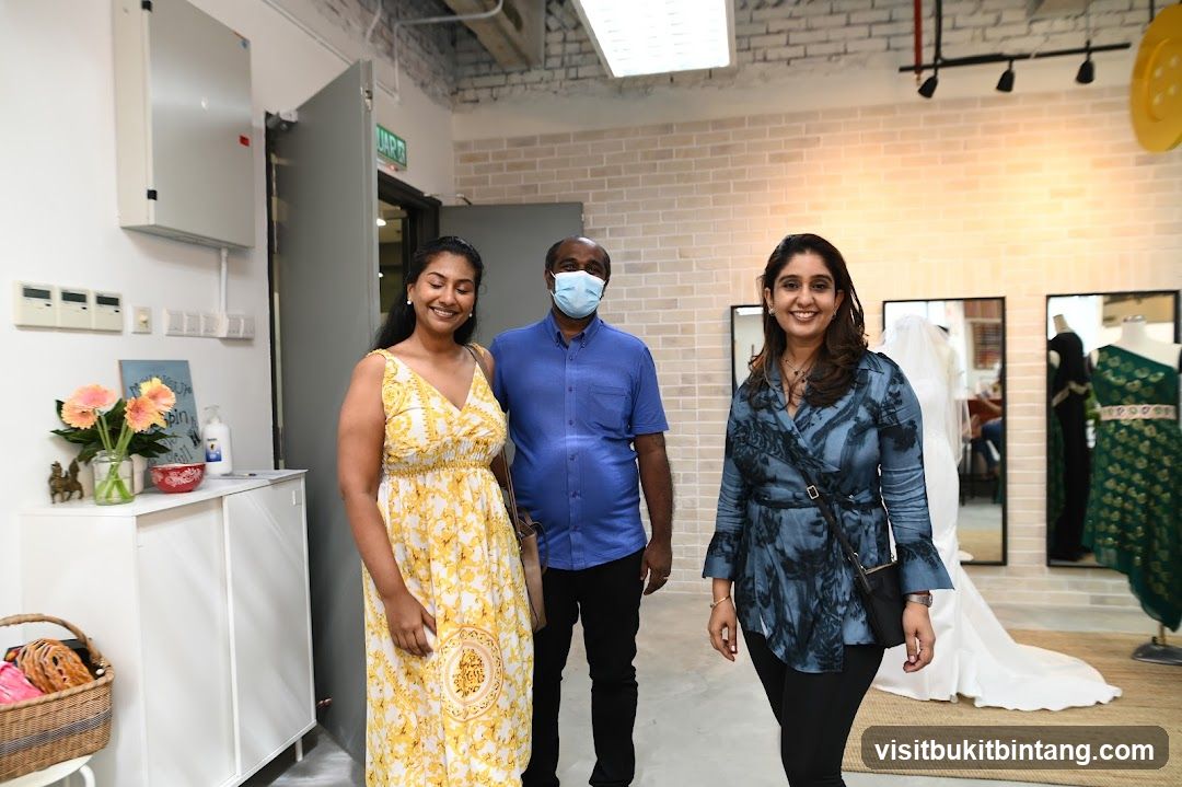 Three people smiling in a boutique