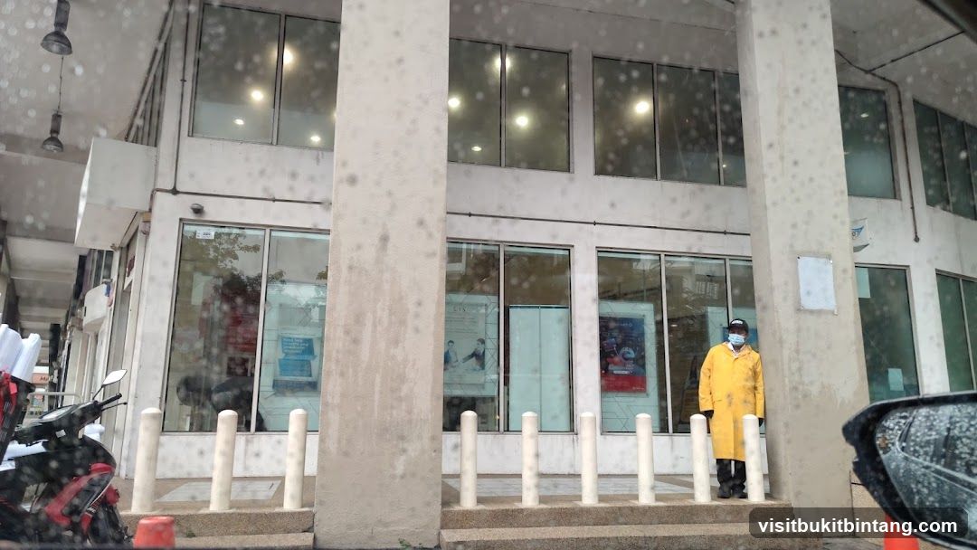 Person in yellow coat outside building