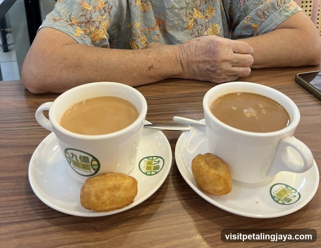 Two cups of milk tea with doughnuts on a table