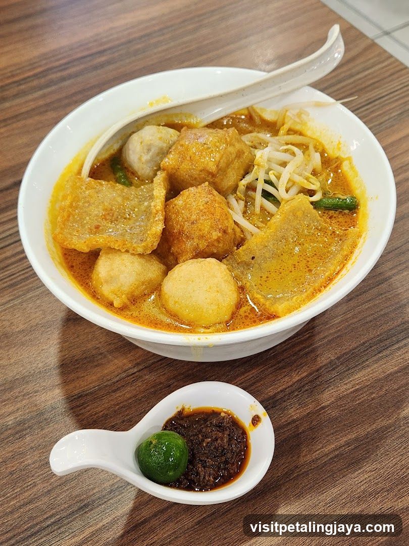 Bowl of Curry Laksa with Side Dipping Sauce