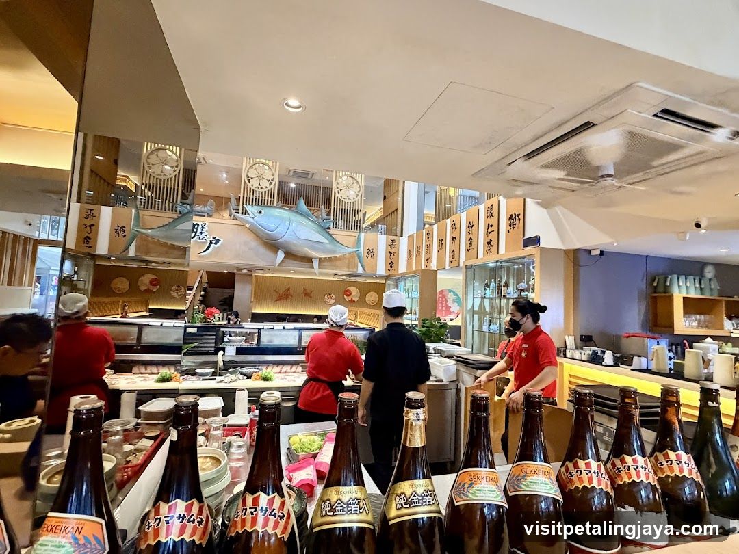 Sushi Restaurant Interior with Staff and Bottles
