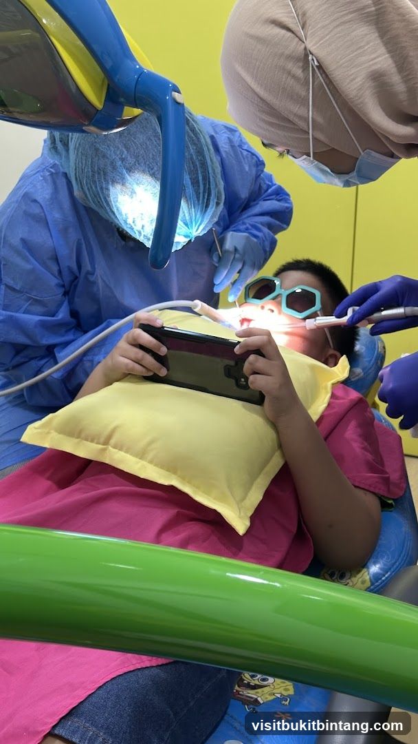Child playing on phone during dental appointment