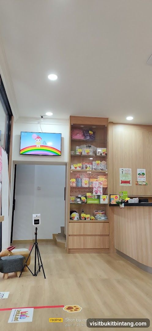 Interior of a store with display shelves and a TV