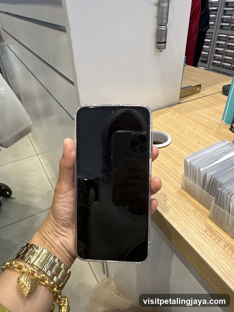 Hand holding smartphone in store interior