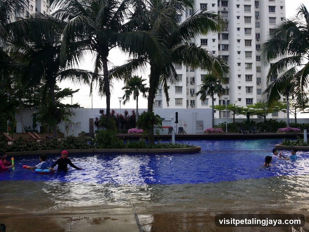 Poolside Scene with Palm Trees and High-Rise Building