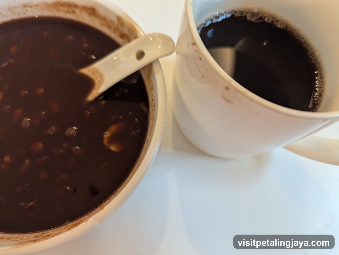 Bowl of dark soup and cup of coffee