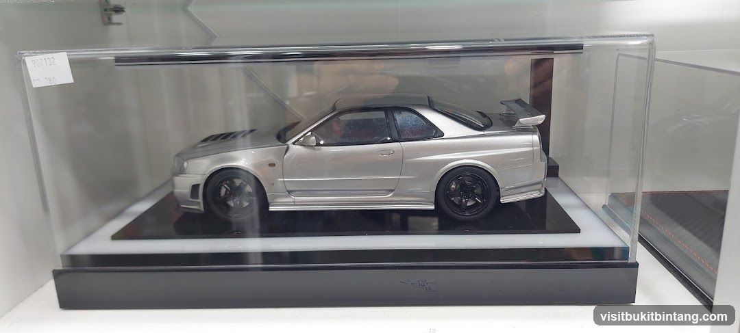 Die-cast model car in display case