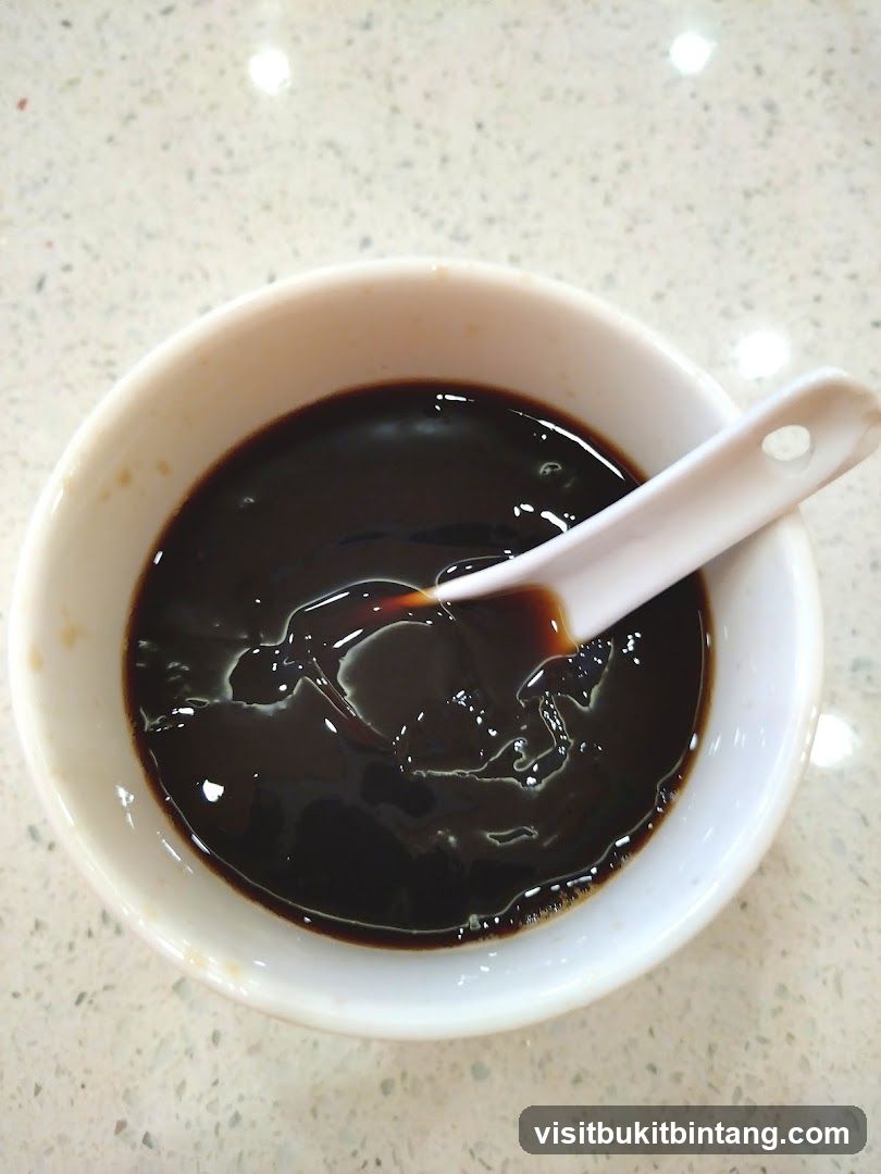 Bowl of Dark Liquid with Spoon