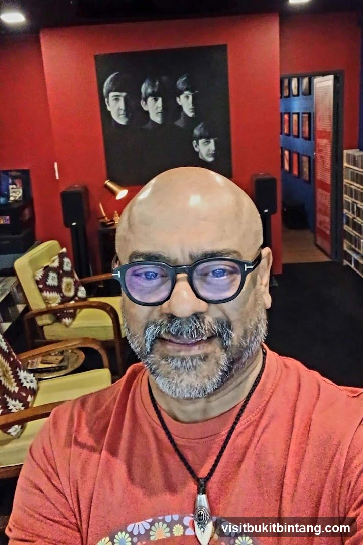 Man in a room with Beatles memorabilia