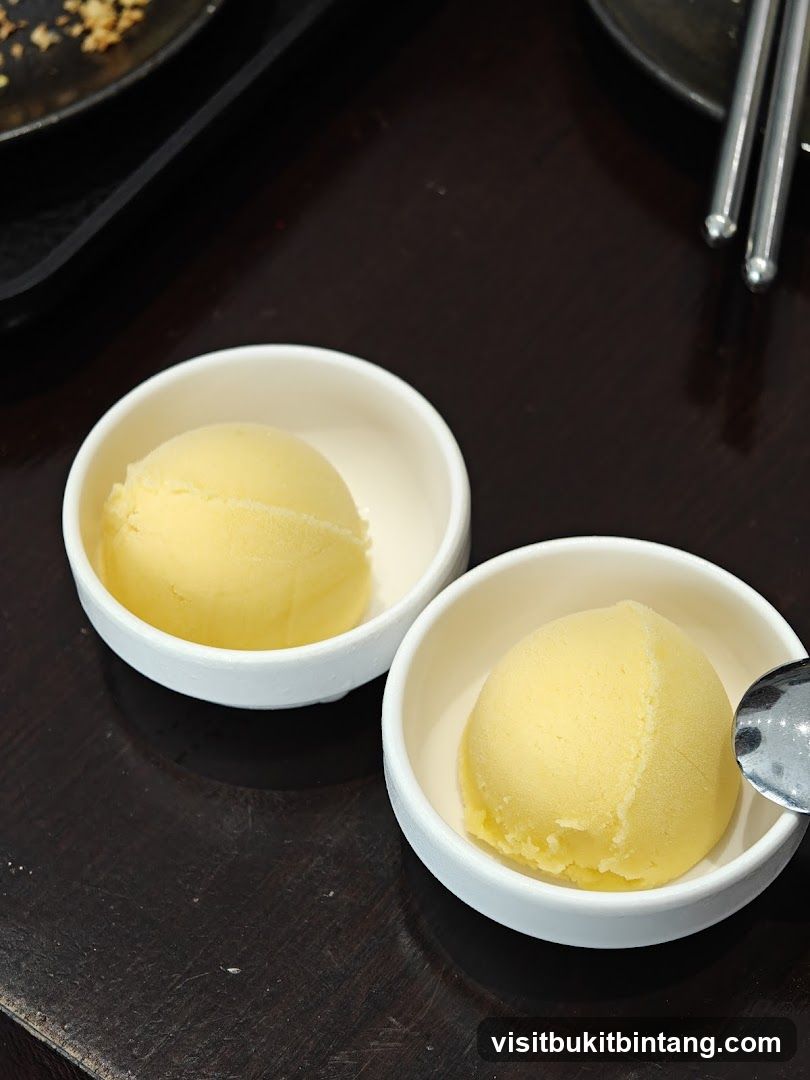 Two scoops of yellow ice cream