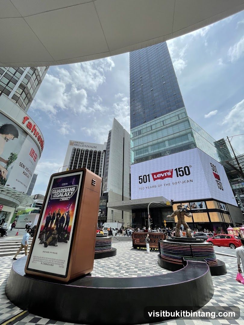 Outdoor plaza with movie and fashion advertisements