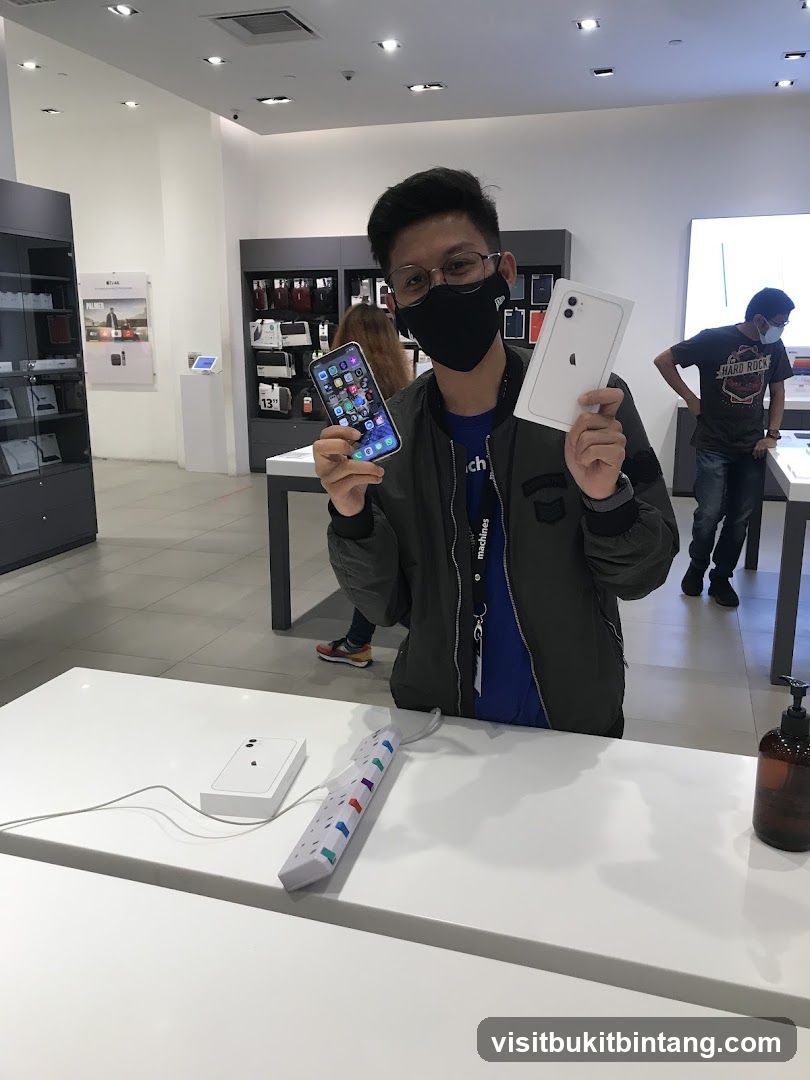 Man holding iPhones in store