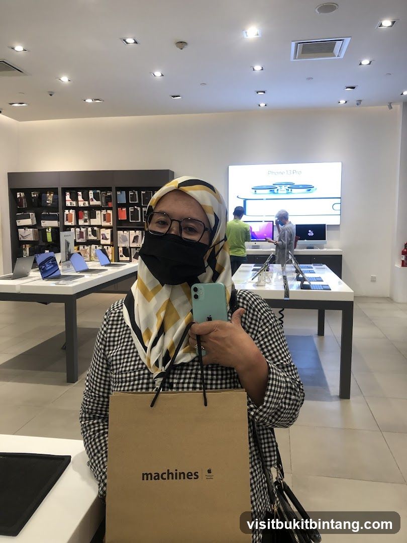 Woman holding a new iPhone in an Apple store