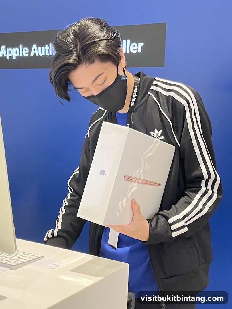 Man holding an Apple product box