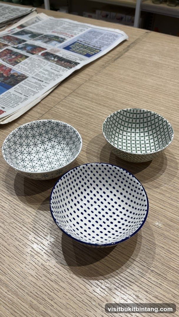 Three patterned ceramic bowls on a wooden table