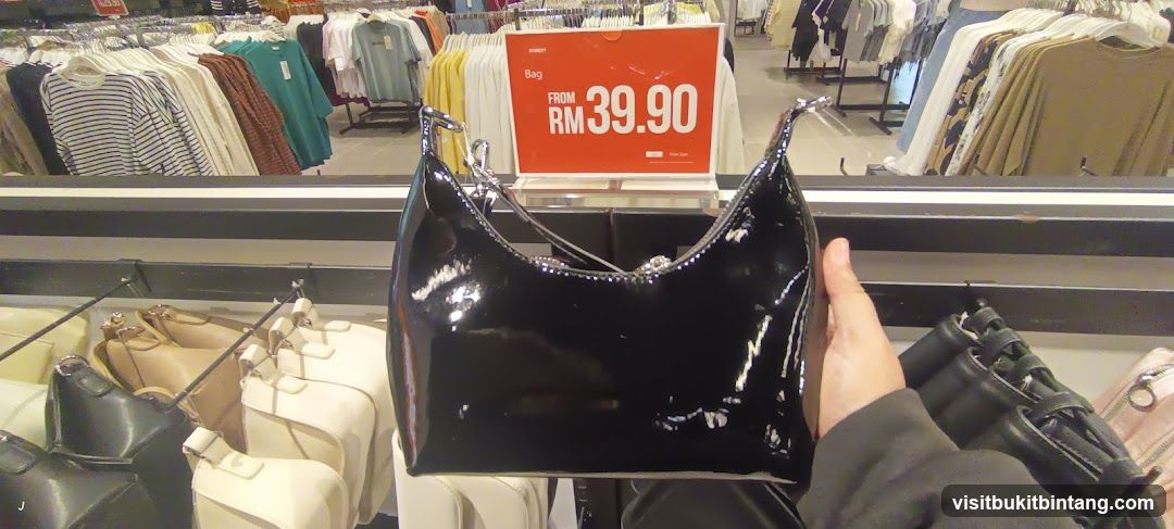 Black patent handbag on display