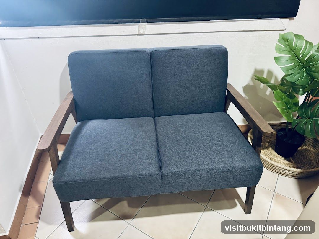 Sofa with wooden arms and a plant