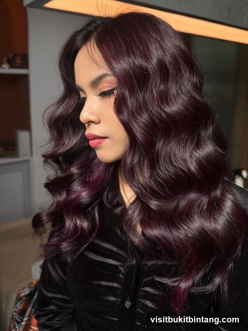Woman with wavy dark hair and makeup