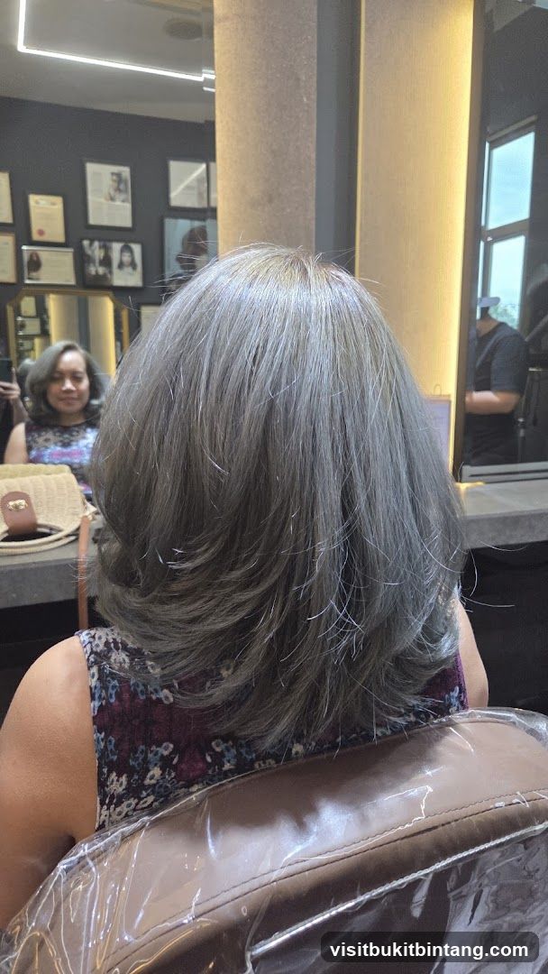 Woman with gray hair in salon