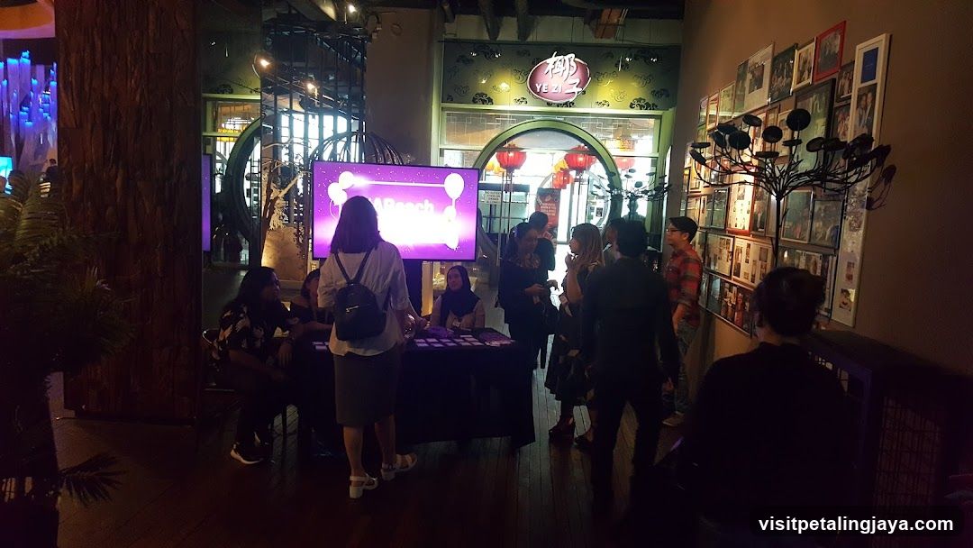 Event Booth with Screen and Crowd