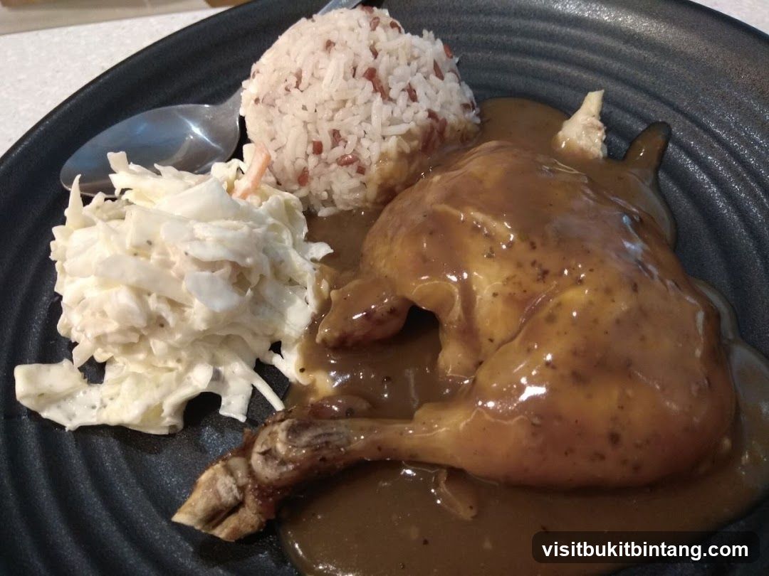 Chicken dish with rice and coleslaw