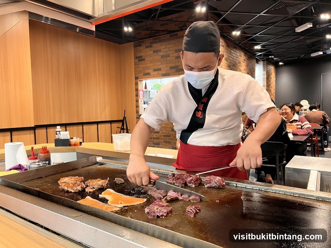 Chef cooking meat on a grill
