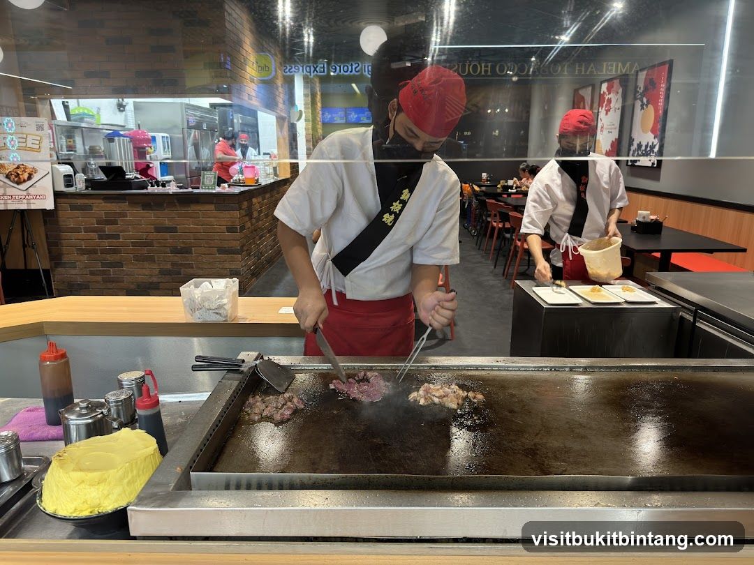 Chefs cooking on a teppanyaki grill