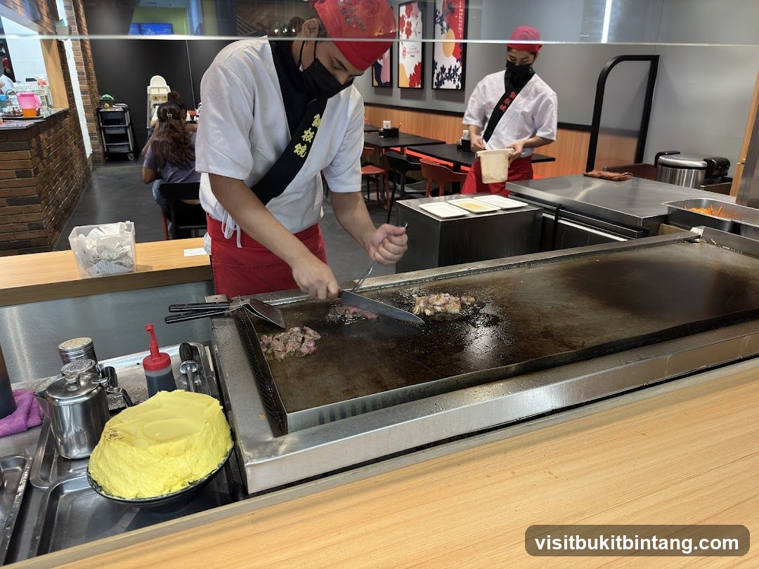 Chefs cooking at a teppanyaki grill