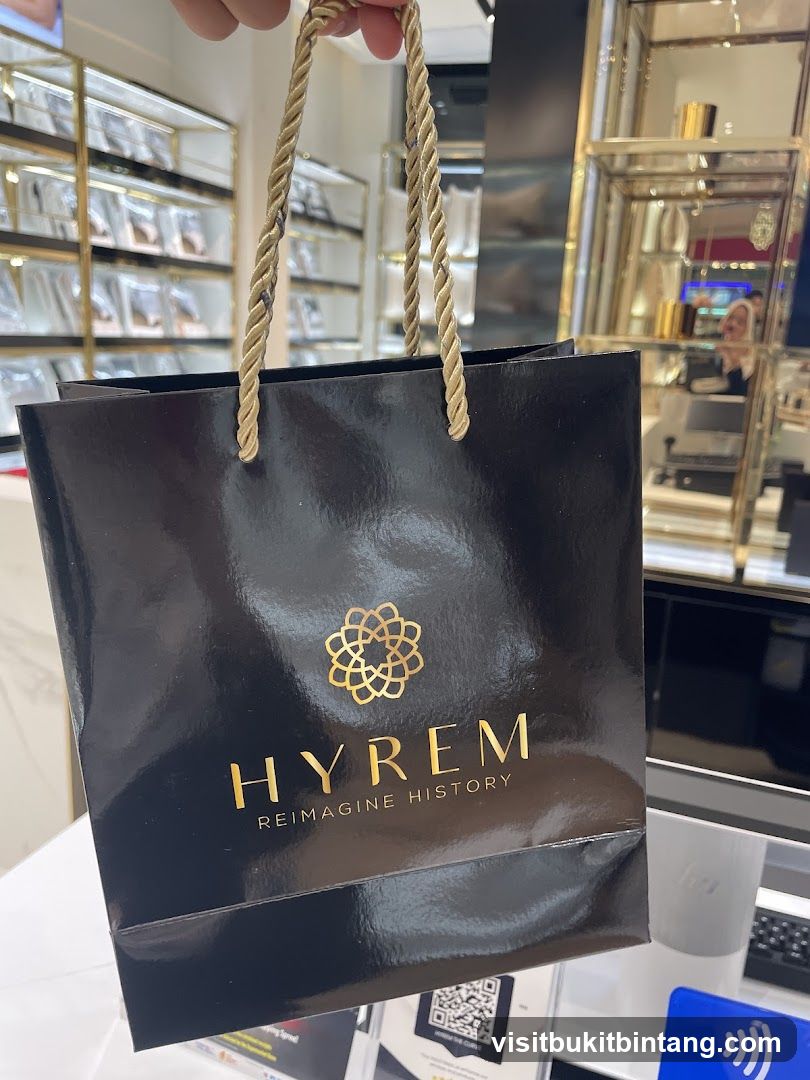 Black shopping bag with gold logo