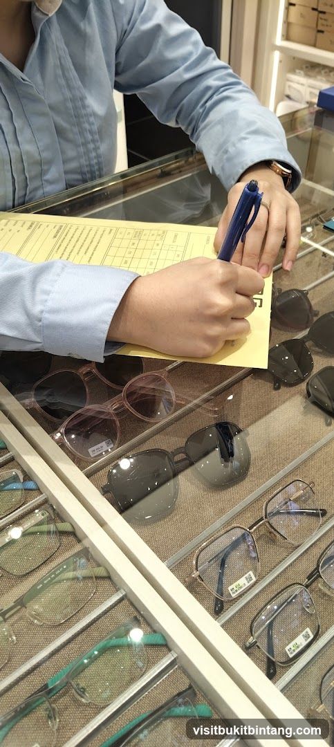 Customer filling out form at optical shop