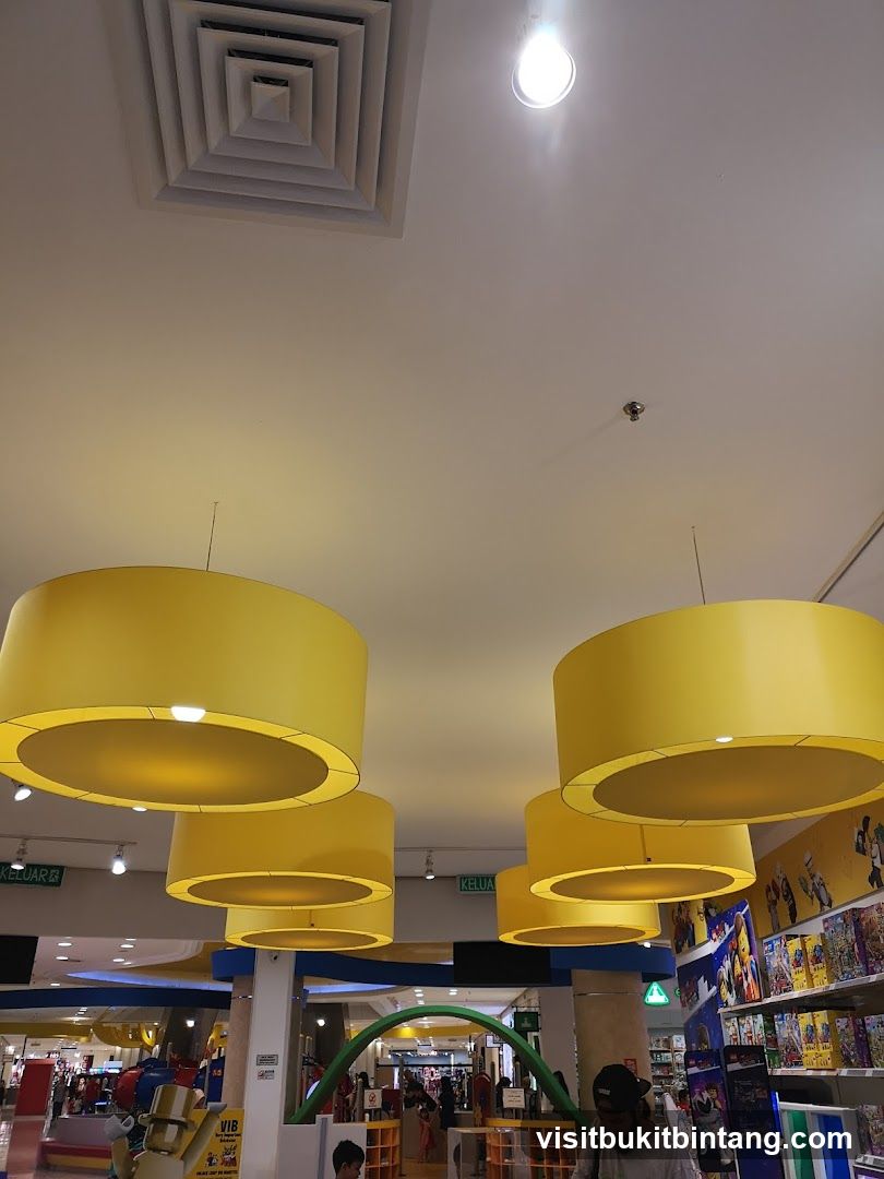 Interior of a brightly lit store with large yellow lamps