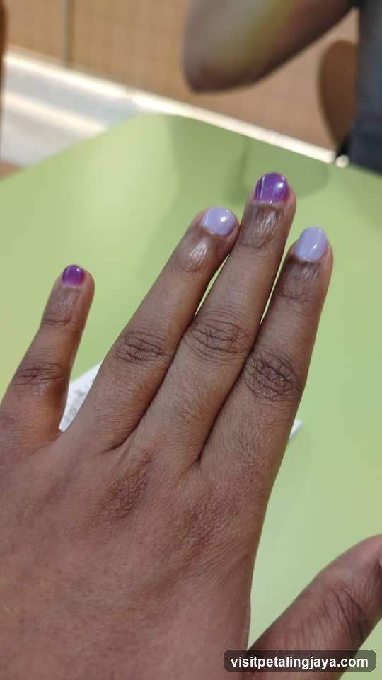 Hand with Manicure on Green Surface