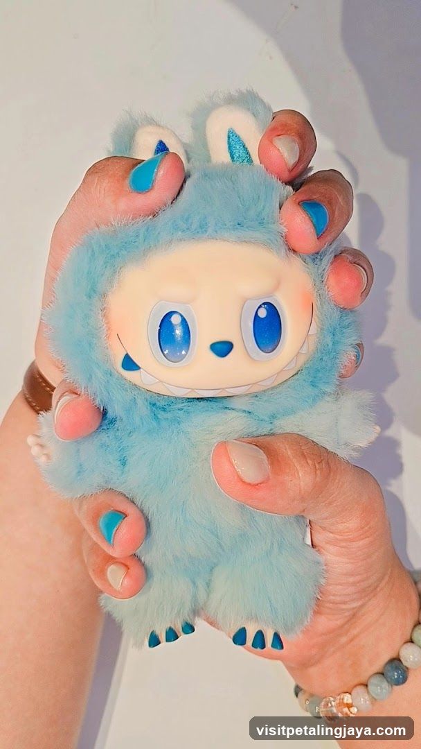 Blue Furry Toy Held in Hands
