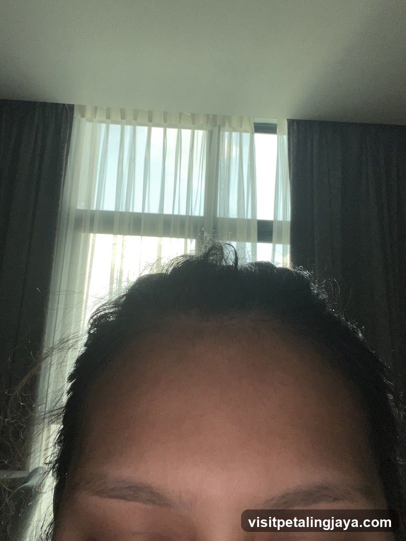 Close-up of forehead and hair near window