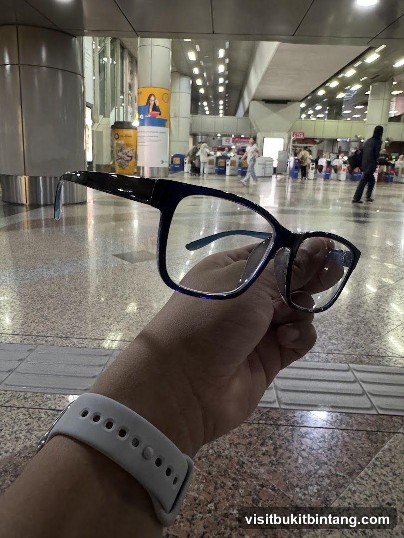 Person holding glasses in an airport